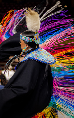 Indigenous dancer with rainbow strings