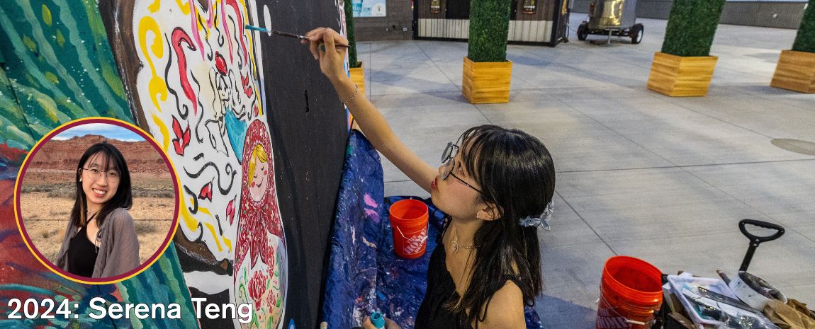 Female artist paining a mural
