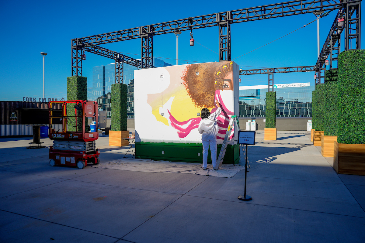 Alumni Camila Ibarra paints new mural on the Coca-Cola Sun Deck at Mountain America Stadium.