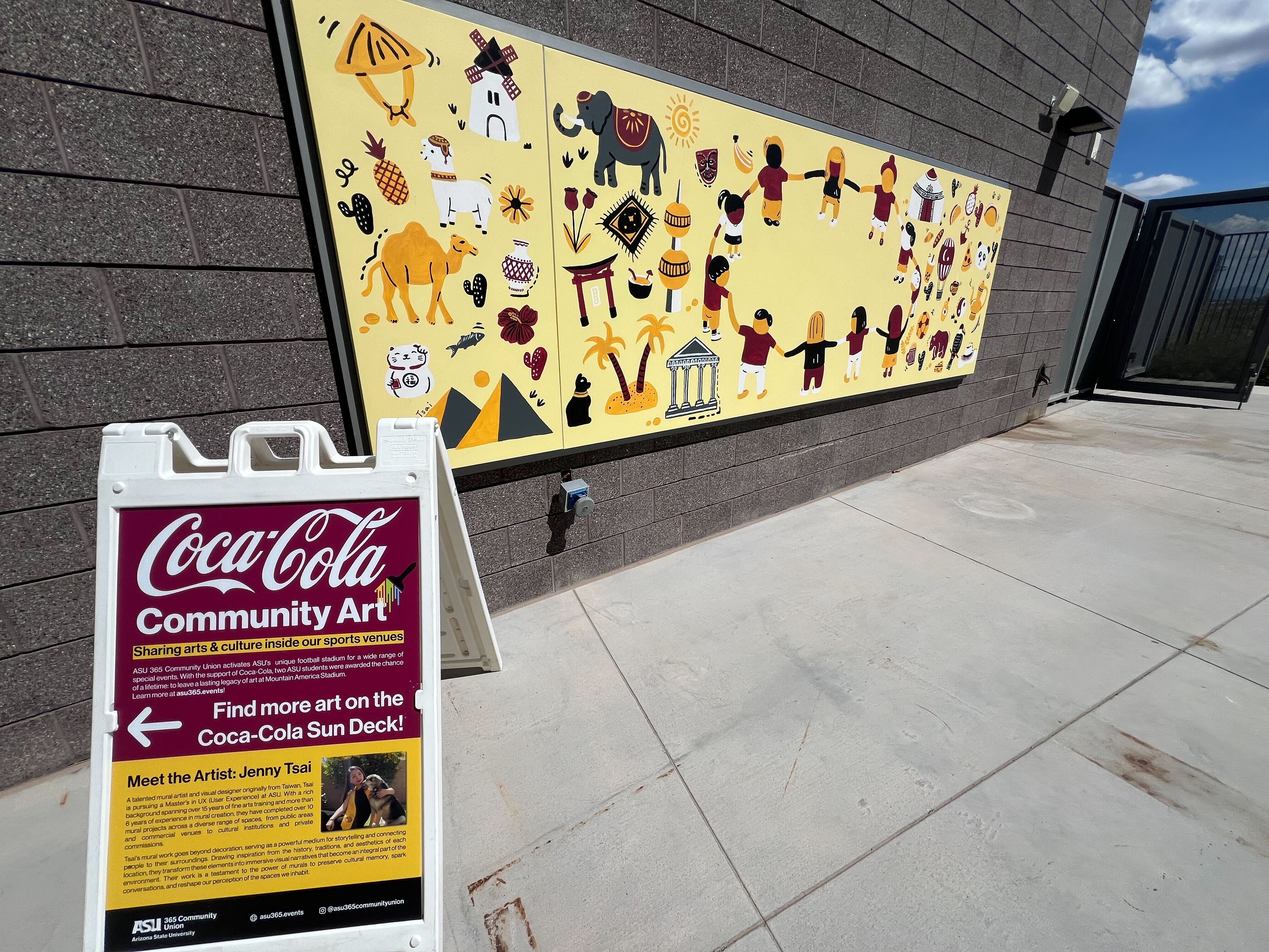 Coca-Cola Community Art mural from the second winner with an a-frame to the left