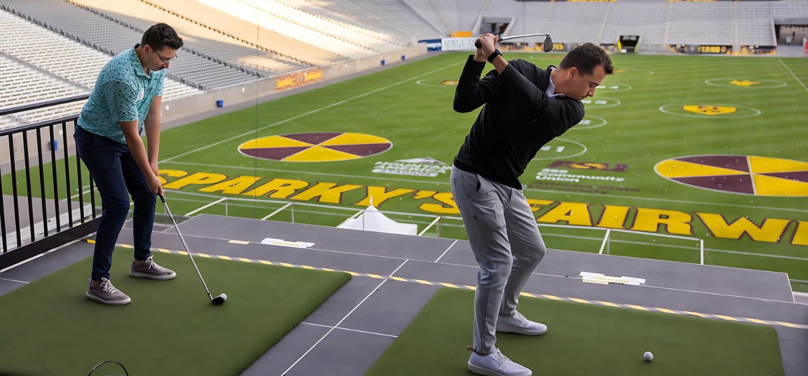 Golfer swinging a golf club inside football stadium