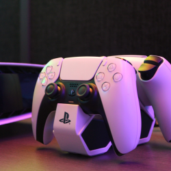 Two white PlayStations controllers in dock