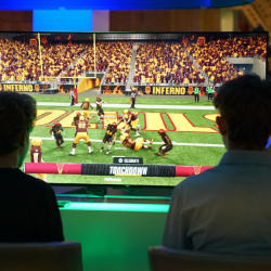 Two students scoring a touchdown on EA College Football 25