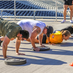Guests using weights for push-ups on the concourse