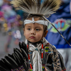 Pow Wow performer in black and gray. Photo by Tim H. Murphy.