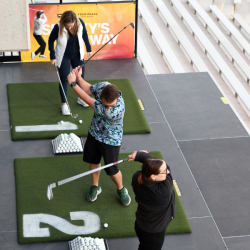 Overhead shot of people swinging at Bay 11, 12, and 13