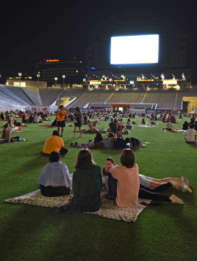 Group sitting on the field for a movie
