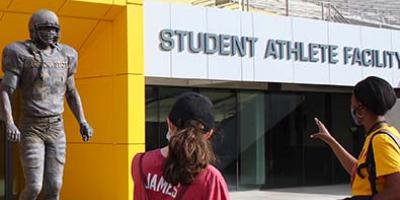 Student Stadium tour at Sun Devil Stadium, students admire Pat Tillman Statue