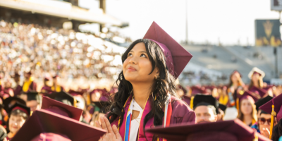 student at graduation looking toward the sky